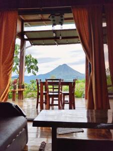 a room with a table and chairs and a mountain at Casa Torre Eco- Lodge in Fortuna