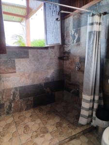 a bathroom with a shower with a shower curtain at Casa Torre Eco- Lodge in Fortuna