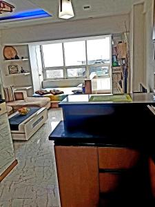 a kitchen and living room with a couch and a counter at Luxury Budget Condo in Central Cebu in Cebu City