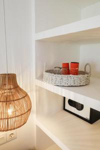 a shelf with two cups and a basket on it at The Room Padang-Padang in Uluwatu