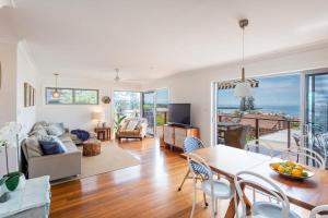 a living room with a view of the ocean at Bimbajong Yamba - oceanstays in Yamba