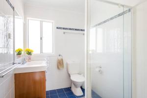a bathroom with a toilet and a sink and a shower at Bimbajong Yamba - oceanstays in Yamba +23 photos