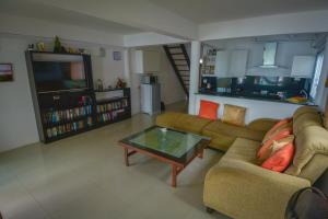 a living room with two couches and a coffee table at Lanta New House in Ko Lanta