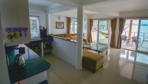 a kitchen and living room with a view of the ocean at Lanta New House in Ko Lanta