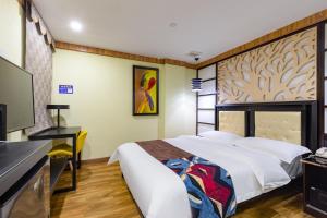 Voodi või voodid majutusasutuse Guangzhou Bird Island Hotel toas