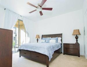 a bedroom with a bed with a ceiling fan at Luxury condo near Irvine Business & UCI Hospital in Irvine