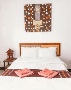 um quarto com uma cama com duas toalhas em DPHouse center of Old Chiang Mai em Chiang Mai