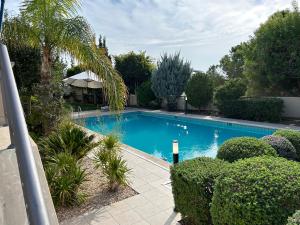 a swimming pool in a yard with trees and bushes at SeaView 5 Bedroom Villa with Private Pool in Limassol