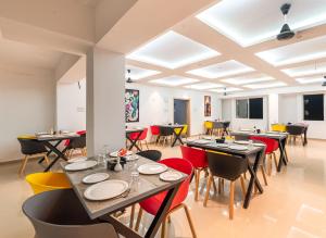 a dining room with tables and chairs at Treebo Trend Cocostay in Pune