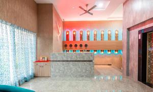 a lobby with a bar with a ceiling fan at Treebo Trend Cocostay in Pune