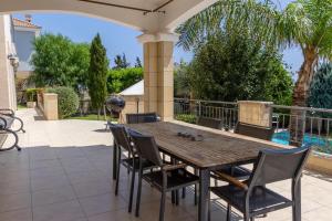 a wooden table and chairs on a patio at SeaView 5 Bedroom Villa with Private Pool in Limassol