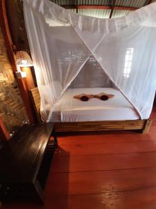 a bed with two bow ties on top of it at Cha Cha Bungalow in Ko Jum