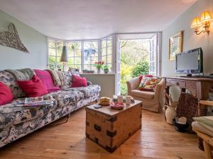 a living room with a couch and a table at Crows Cottage in Fishguard