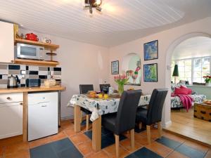 a kitchen and dining room with a table and chairs at Crows Cottage in Fishguard
