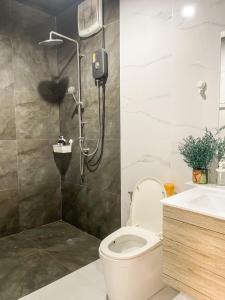 a bathroom with a shower and a toilet and a sink at Peaceful & Contemporary Duplex Escape in Ban Thap Nang