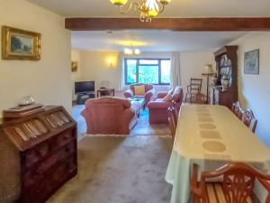 a large living room with a table and chairs at Gors Y Gader in Llanelltyd