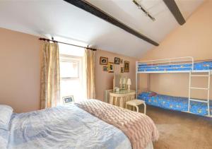 a bedroom with a bed and a bunk bed at Ty Nain in Caernarfon