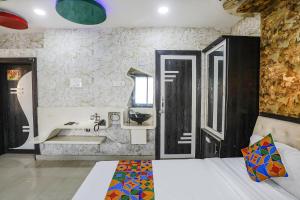 a bathroom with a sink and a mirror at FabHotel Greenland Classic - Bhubaneswar Airport in Bhubaneshwar
