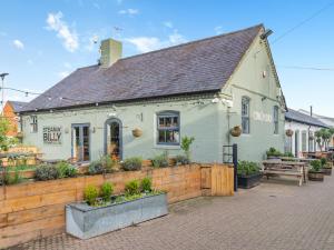 a white building with a fence in front of it at Barn Owl - Uk45517 in Humberstone