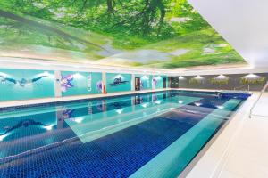 a large swimming pool with a large ceiling at Nest Cottage in Bodmin