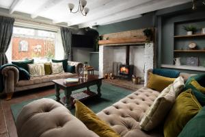 a living room with a couch and a fireplace at Owl Cottage in Morpeth