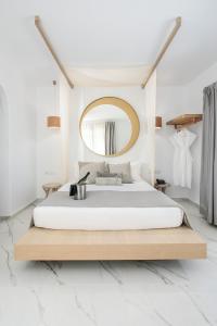 a bedroom with a large bed and a mirror at Cosmos Hotel in Plaka