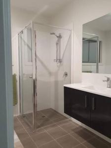 a bathroom with a glass shower and a sink at JervisBayStays TheSanctuaryFour in Sanctuary Point