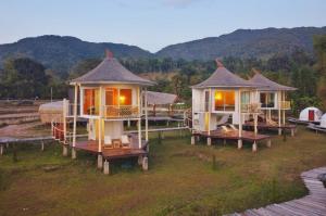 a group of cottages sitting on top of a field at Vieng Sava in Ban Huai Ti