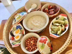 a wicker tray with bowls of food on a table at Huen Chaivaree in Nan +10 photos