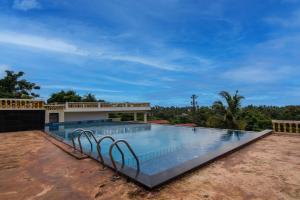 a swimming pool on top of a house at Capital O The Great Ocean View in Mandrem