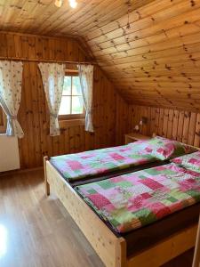 a bedroom with a bed in a wooden room at Haus Katrin in Sankt Marein bei Knittelfeld