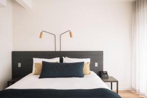 a bedroom with a large bed with a black headboard at Hotel Sorrento in Sorrento