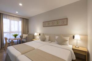 Postel nebo postele na pokoji v ubytování Kantary Hotel Banchang