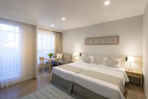 Postel nebo postele na pokoji v ubytování Kantary Hotel Banchang