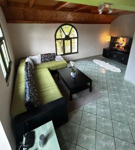 a living room with a couch and a fireplace at Apartman Tóth György in Bačka Topola