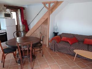 a living room with a table and a couch at Maison vue sur Cher in Bruère-Allichamps