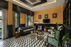 a living room with a couch and a table at City Connect by Downtown Udaipur in Udaipur +27 photos