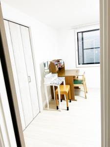 une salle à manger avec une table et des chaises jaunes dans l'établissement 花乃郷 本郷, à Tokyo