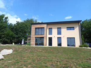 a house on a hill with a yard at Les Terrasses du Phenix in Saint Alban Auriolles