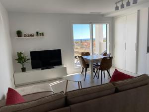 A television and/or entertainment centre at Playa Flamenca - Turquesa del Mar - great sea view!