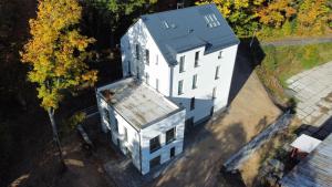 an overhead view of a white building with a blue roof at Pernink Pod nádražím in Pernink