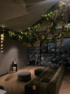 a living room with a couch and christmas lights at HOUSE38 Panoramic View Apartments SELF CHECK-IN in Kaunas