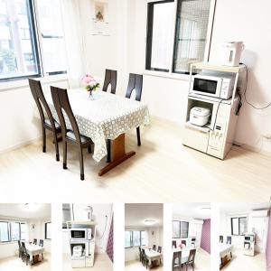 Zimmer mit einem Tisch, Stühlen und einer Mikrowelle in der Unterkunft 花乃郷 本郷 in Tokio