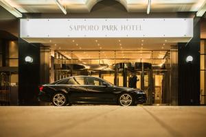a black car parked in front of a store at Sapporo Park Hotel in Sapporo