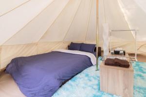 a bedroom with a bed in a tent at Glamchette Okayama -Glamping & Auto Camp- - Vacation STAY 44593v in Mimasaka