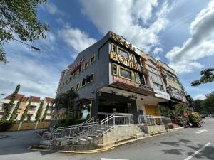 a building with a sign on the side of it at Seeds Hotel Wangsa Maju in Kuala Lumpur