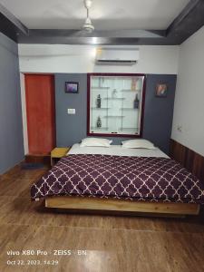a bedroom with a large bed with a window at Sunshine Service Villa in Kannur +33 photos