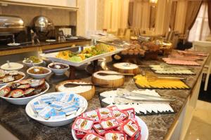 a buffet line with plates of food and appetizers at Premier Palace Baku in Baku