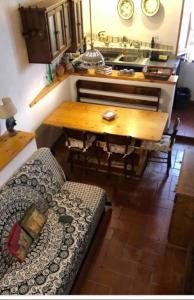 a living room with a couch and a wooden table at Casa Della Rosa in Pitigliano