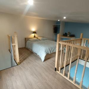 a bedroom with a bed next to a staircase at Loft entier, calme, fibre et wifi in Saint-Quentin